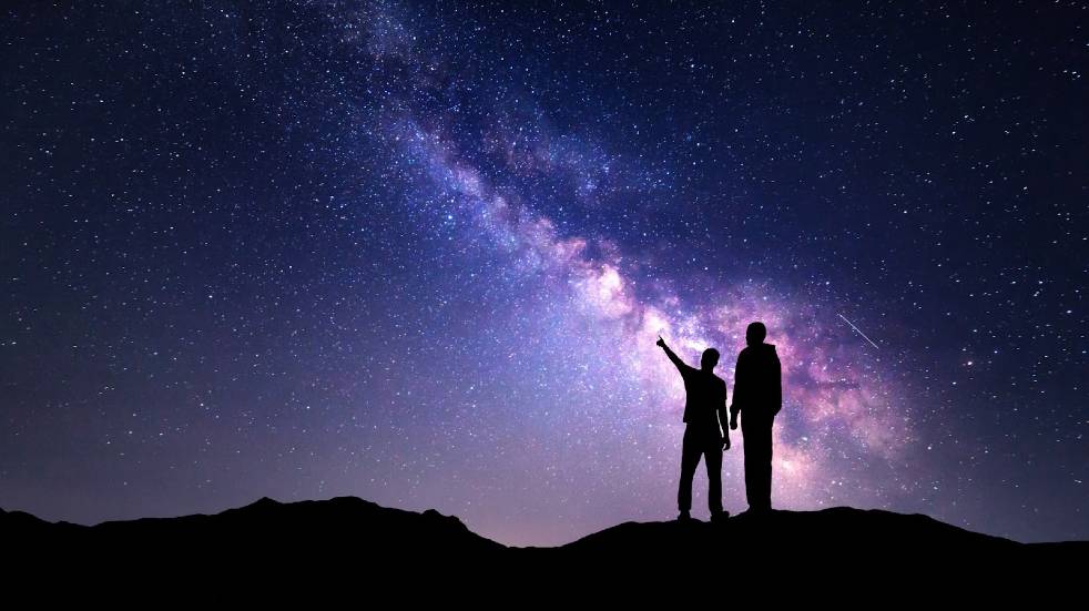 Man and boy stargazing
